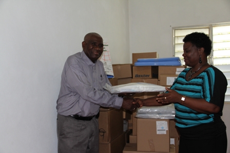 Director of the Development Projects Foundation Mrs. Myrthlyn Parry, hands over a donation of medical supplies from charitable US based organisation Hospital Sisters Mission, to Chairman of the Board of Directors of the St. Georges and St. Johns Senior Citizens Home in Gingerland Reverend Cannon Dr. Alson Percival